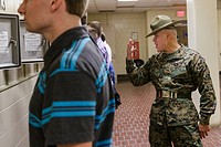 US Marine Corps Drill Instructors direct newly arrived recruits through receiving at Marine Corps Recruit Depot Parris Island to begin 13 weeks of boo...