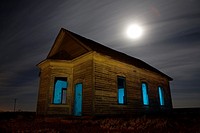 Abandoned Taiban Presbyterian Church in New Mexico at night with star trails.
