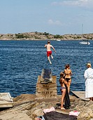 Kid jumps to the sea, Fjallbacka, bohuslan region, west coast, Sweden.