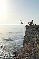 Locals jump from a cliff in Verudela, nearby Pula.