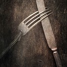 Still life with silverware on table. Knife and fork on a wooden background.