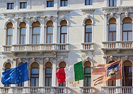 Flags of the European union, Italy and the Venetian flag flying on the Palazzo Ferro Fini, Venice, Veneto, Italy, Europe.