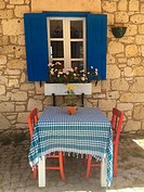 Lonely table waiting for guests at the cafe in Alacati town, the historic centre of Zeytineli Koeyue, Cesme, Izmir, Aegean Coast, Turkey, Europe.