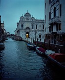 Venetian canal at dusk and the Scuola Grande di San Marco Hospital in the Castello district of Venice, Italy, Europe