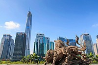 Shenzhen, China - August 19,2015: Stock market building in Shenzhen, one of the three stock markets in China, with the copper bull statue on foregroun...