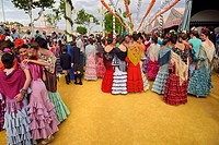Young female students dressed in flamenco dresses at the April Fair in Seville.