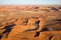 Sand dunes in the Namib Desert. Top right the Witberg (White Mountain, 426m), a granite massif in the centre of the Namib Desert. The trees are Camelt...