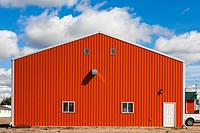 Orange agricultural building in the town of Castor, Alberta, Canada.