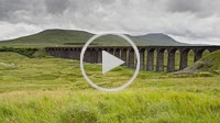 Time lapse of the Ribblehead Viaduct with Ingleborough behind and a passing steam train Yorkshire Dales England
