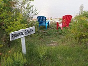 Colorful charis and private beach sign in Ephraim on Green Bay Door County Wisconsin.