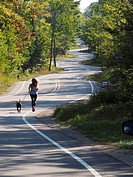 Wisconsin Door County Elison Bay Windy Road with female runner and dog.