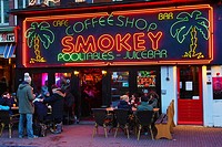 Neon lights on the sign of the Smokey Coffeeshop where taking and smoking drugs like marijuana is legal in Rembrandtplein in Amsterdam, Holland.
