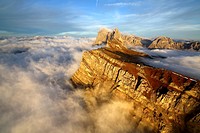 Aerial shot from Seceda of Odle surrounded by clouds at sunset. Dolomites Val Funes Trentino Alto Adige South Tyrol Italy Europe.