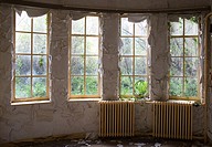 Room with windows and paint peeling of in abandoned house for the elderly people in holland