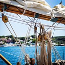 Close up of masts and rigging from a vintage boat, with a blue sky in the background. pulleys, sails and ropes. Port Mahon, Menorca, Biosphera Reserve...