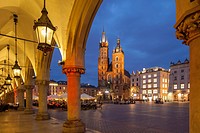 Night falls at the Cloth Hall in Krakow old town, Poland. Looking towards St Mary´s church. UNESCO world heritage site.