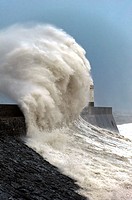 Huge waves crash against the harbour wall at Porthcawl, Bridgend, Wales, UK.