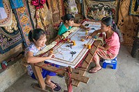 Women create beautiful embroidery by hand in a small roadside factory.