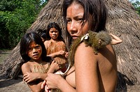 Yagua tribe located near Iquitos, Amazonian, Peru. Portrait of some adolescents living in the village with his pet, a little pygmy marmoset (the small...