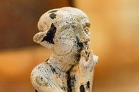 Egypt, Cairo, Egyptian Museum, statuette coming from Tell el Farkha, early Dynastic period, in hippopotamus tusk. Sitting boy.