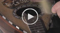 cleaning button and the frets of an old mandolin