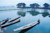 An early morning boater sets out from Garden Island Cottages at Inle Lake.