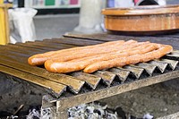 Fried sausage on barbecue, restaurant and food.