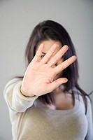 Woman showing a stop hand gesture.