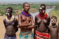 Young topless female teens and children of the Karo tribe. Photographed in the Omo Valley, Ethiopia.
