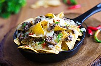 Nachos with haggis, melted cheese and chilli peppers.