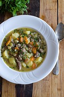 Lamb, potato and vegetable stew topped with chopped chives and parsley.
