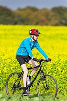 Young man riding his bike in the countryside, Lower Saxony, Germany, Europe