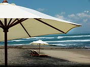 Typical umbrellas on the beach in Canggu, Bali Island, Indonesia.