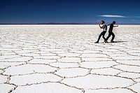Boys having fun in the spectacular Uyuni salt flats, Bolivia.
