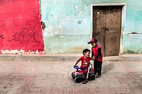 Children playing in one of the colorful streets of the small town of Samaipata, Bolivia