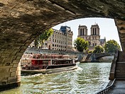 Notre Dame Cathedral viewed from the River Seine under the Petite Ponte bridge, Paris, France