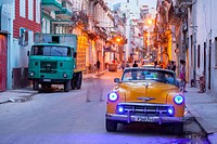 A classic American car at night in Centro Habana at dusk. Havana, Cuba.