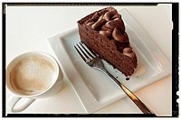 Snack with coffee and chocolate cake with photo frame in black