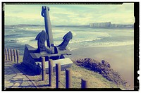 Salinas beach with an anchor in the foreground view from the Philippe Cousteau museum, Salinas, Asturias