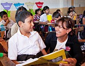 Mixco, Guatemala, Sandra Reemer (dutch famous artist) is reading a book to a boy in school. Sandra sponsored this school together with other investors...