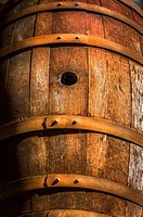 Old wine barrel, dried-out with rusting hoops.