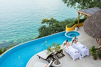 View from above at two women getting a massage on the terrace of an ocean front luxury wellness retreat in Mismaloya, Puerto Vallarta South Shore, Jal...