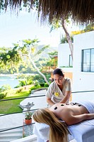 Massage therapist treating a female customer at luxury wellness retreat in Mismaloya, Puerto Vallarta South Shore, Jalisco, Mexico.