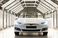 Tilburg, Netherlands. A brand new Tesla Model S gets checked out under an abundance of light.