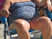 Senior woman sitting in beach chair