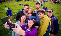 People taking a group selfie enjoying the The Big Tribute Music festival, Aberystwyth, August Bank Holiday weekend, Summer 2015.