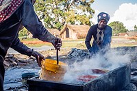 Women prepare anchovies, locally called Dagaa, for drying at Mkokotoni village, Zanzibar. Local people use dagaa for preparing food as itâ. . s much c...