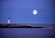 large moon over peggy's cove lighthouse in nova scotia.
