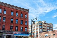 Brooklyn, NY, Greenpoint, Franklin Street. Typical Red Brick Tenement Block of Apartments Above and Retail Stores on the First Floor. Factory Building...