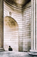 Person walks under the arch of The Bank Of England ,City of London,England.
